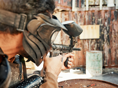 Someone aiming a paintball at their target