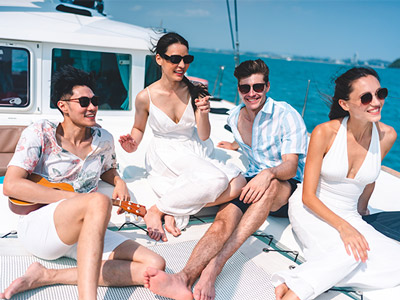 Two couples relaxing and enjoying a private catamaran