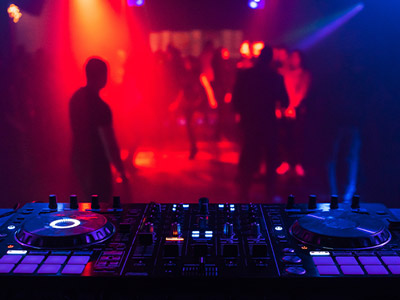 A DJ deck in front of a dance floor 