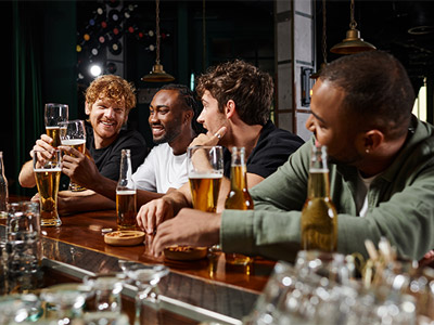 A group of men having a pint on a bar crawl