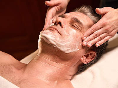 A man receiving a skin treatment at a mobile spa