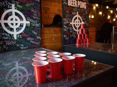 Red cups and a ping pong ball set up on a table ready for beer pong