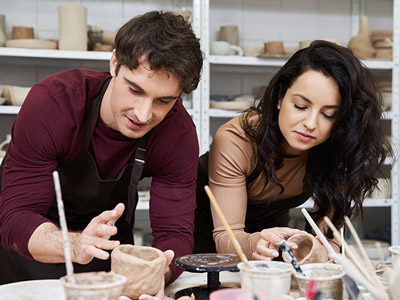 Couple painting ceramic sculptures
