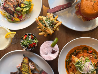 A selection of brunch dishes including a burger, a pasta dish and a side salad 