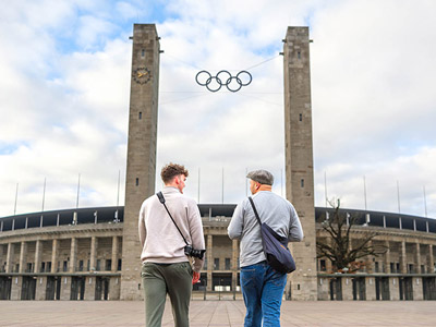 The front of the Olympic Stadium, Berlin, with the Olympic logo between two towers