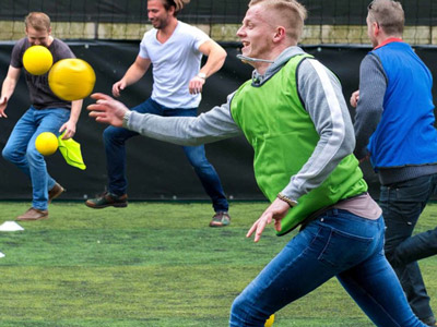 A man who has just thrown a ball whilst playing a game of dodgeball 
