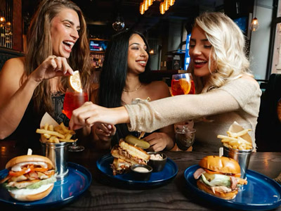 Three women on a hen do enjoying a meal and some drinks at Manahatta 