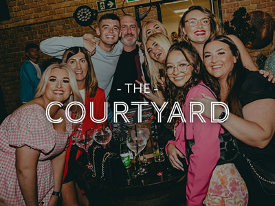 A mixed gender group drinking with The Courtyard logo layered over it 