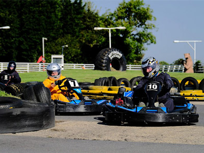 Three people racing in go karts in Nottingham