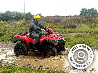 Close up of a man driving a quad bike outdoors 