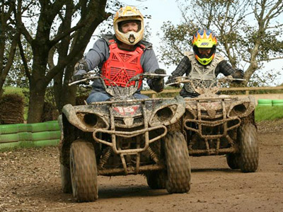 A man driving a quad bike into the wilderness