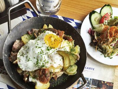 A pan of food next to a dish on a white plate