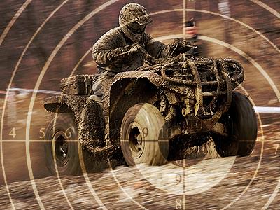 A faded image of a sniper target on an image of a man driving a quad bike through a muddy field