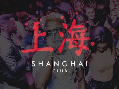 A man singing into a microphone in front of a large group of people