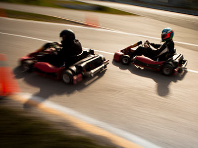 Two go karts racing on an outdoor circuit