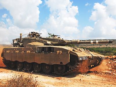 A main battle tank on a dirt track