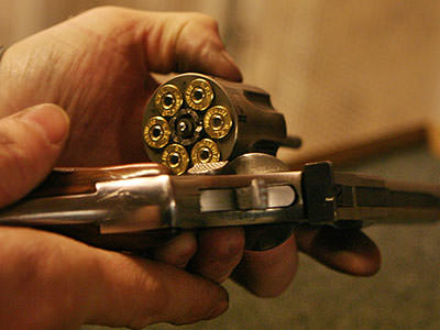 Close up of the barrel of a pistol filled with bullets