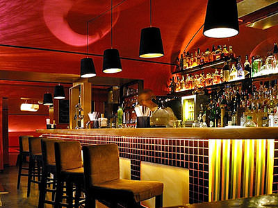 Bar stools in front of a yellow bar
