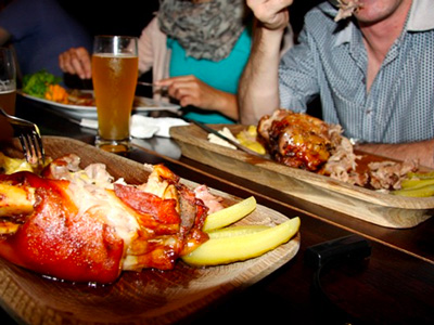 A stag enjoying his pork knuckle in a Krakow brewery