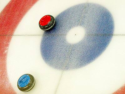 Close up two discs on an ice curling track