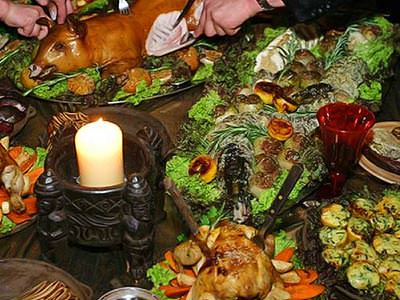 A medieval feast, set up on a table, with a candle in a balck holder - Rank #8