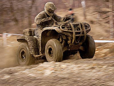 A man driving a quad bike through the wilderness