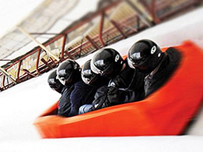 Five people sat in a red soft bobsleigh on an ice track as part of a stag do in Riga - Rank #7