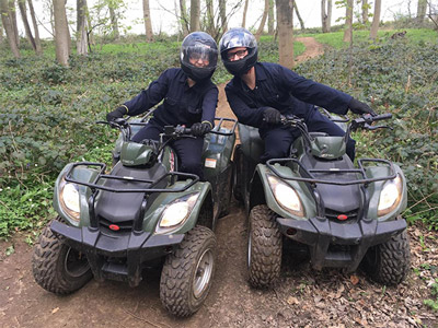 Some quad bikes driving through the forest 