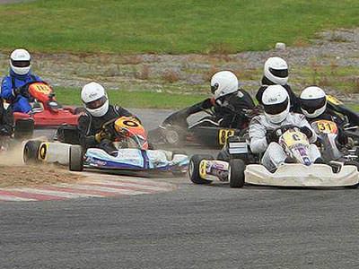 Aix people driving go karts with one driving in the wrong direction