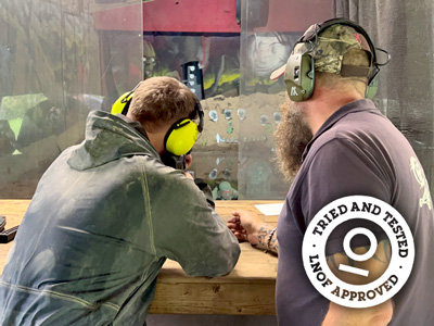 A man aiming a rifle at his target at assault rifle shooting