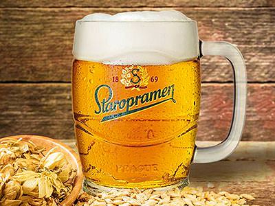 Close up of a full Staropramen Brewery tankard, with ingredients next to it