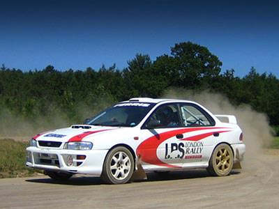 A sports car making the dust fly up behind it