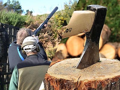 Split image of the back of a man shooting a shotgun, and an axe in a log