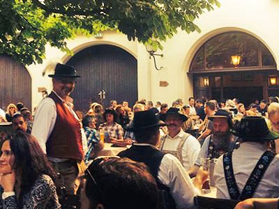 People sat on benches outside a beerhall - Rank #2