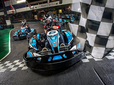 Black and white close up image of someone riding a art in a helmet