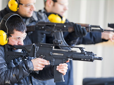 The silhouette of a person posing with a handgun