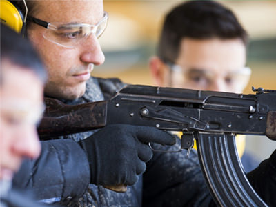 The silhouette of a person posing with a handgun
