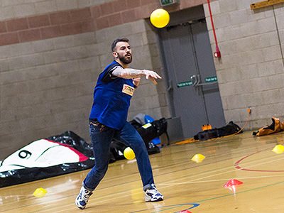 Group of people posing in 80s style dodgeball outfits