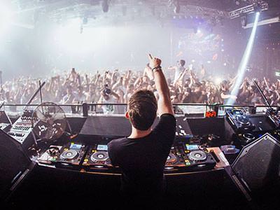 A DJ performing to a massive crowd