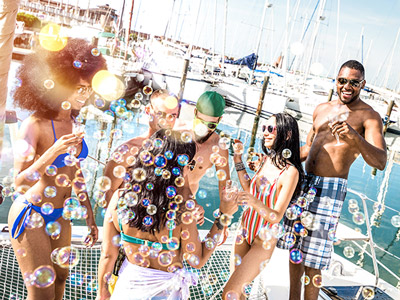 girl wearing bikini and sunglasses partying on a boat