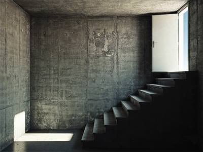 An empty room with a staircase leading outside