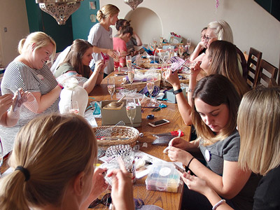 A group of women making fascinators in a workshop