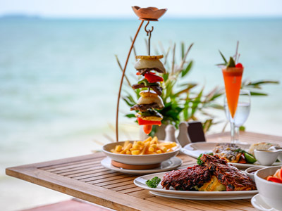Mussels in a bowl, with bread on the side and a small bowl of chips 