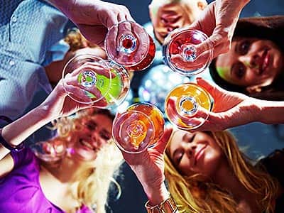 Five girls holding their drinks in the middle of their group