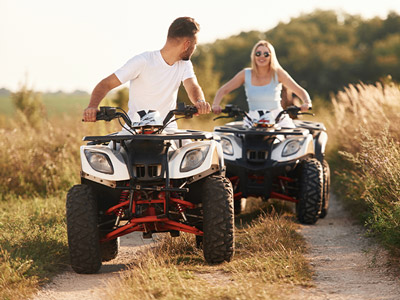 A girl on a quad bike in the sun