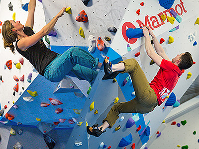 A split image, one of a man and a woman climbing separate climbing walls