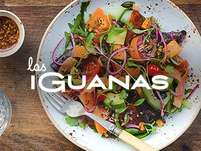Colourful salad on a plate, served next to a bowl