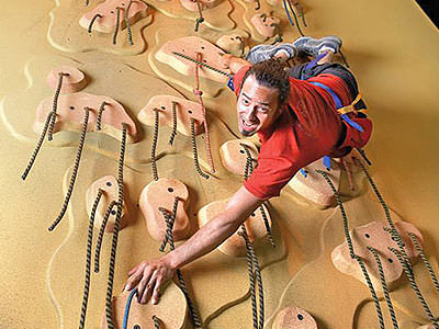 A man climbing on a climbing wall
