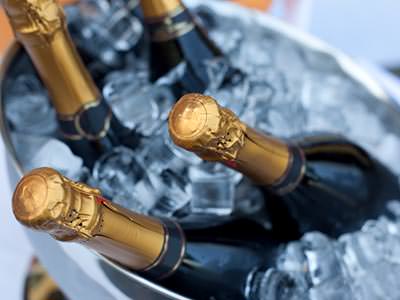 Four bottles of Prosecco chilling in an ice bucket