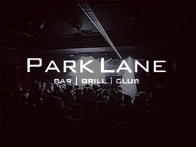 Dark image of people in a club, to a backdrop of white light